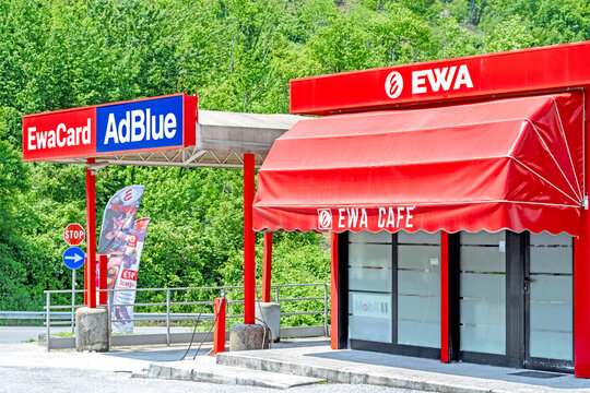 Red EWA Caf&eacute; fuel station with AdBlue and EwaCard signage, roadside service area surrounded by green trees,in Atina along the Sora-Cassino freeway in the Italian Lazio region.