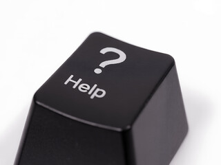A close-up of a black computer keyboard key displaying the word "help" and a question mark symbol