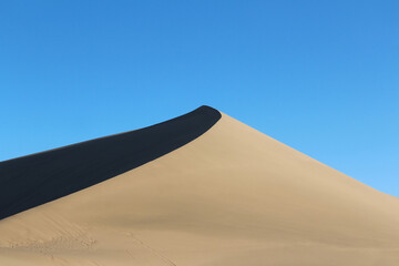 Beautiful sand dunes at Singing Sand Dunes (Mingsha Shan) and Crescent Moon Lake, Dunhuang in Gansu Province of China © Crystaltmc