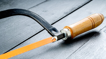 Hacksaw on a black table