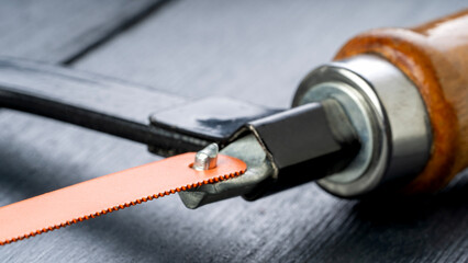 Hacksaw on a black table