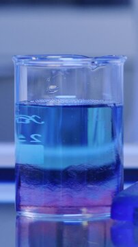 Chemical, beaker and liquid with mix in lab for forensic pathologist, research or sample analysis. Toxicology exam, medical study and chemistry with scientist and experiment for drug screening