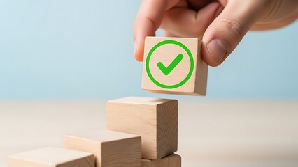 Hand placing block with check mark on stack representing success and positive results