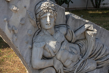 An ancient bas-relief on a marble surface. Antique carvings depicting fabulous creatures. the surface of the stone. Ancient Greek myths in marble. Ruins of an ancient city.