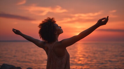 Woman practicing mindfulness stretching arms by the serene sea during a beautiful sunrise