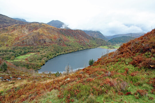 Llyn Dinas lake in Snowdonia Mountain Range near to Beddgelert, North Wales, on a wet and windy Autumn day with pouring rain