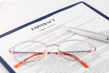 Signing the contract with pen and glasses in business work.