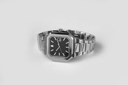 Luxury Stainless Steel Square Watch with Black Dial on Minimalist Gray Background