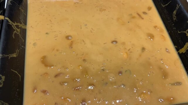 Nolen gurer paes prepared with rice, milk, cashews and raisins in Kolkata, India
