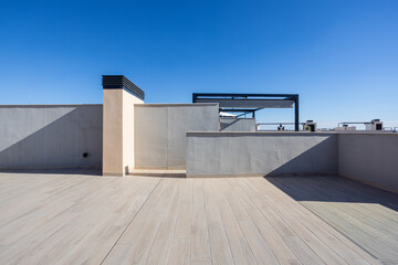 Modern rooftop terrace with tiled flooring and clear sky