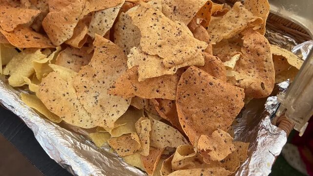 Masala papad served in an aluminum foil tray 
