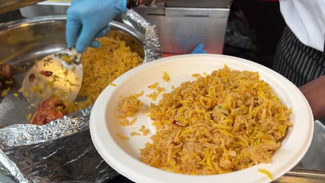 Spicy Kolkata-style chicken Biryani being served in an event in India
