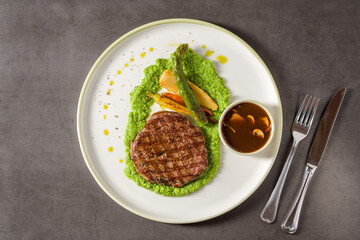 Grilled tenderloin served with green puree and rich mushroom sauce