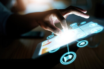 Person, hand and tablet at night with hologram, UI or 3D HUD and dashboard with icons on desk at office. Closeup of employee working late on technology in digital marketing or networking at workplace
