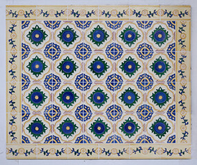 Rows of antique Nyonya Tiles with blue flowers on light beige base. Traditional Peranakan cultural in Penang. Vintage Baba & Nyonya style floral tile pattern