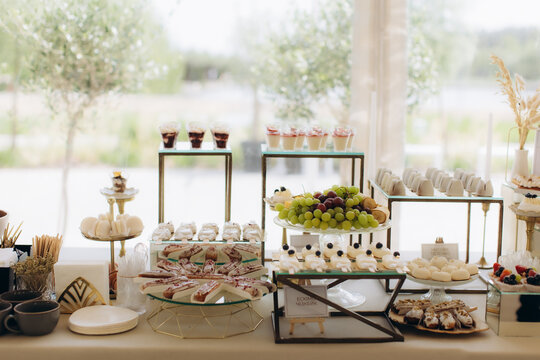 Dessert table offering various sweets and fresh fruits