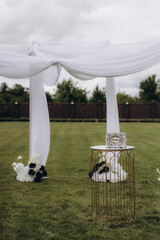 Outdoor wedding ceremony arch in green garden