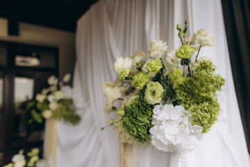 Wedding ceremony floral decor with white and green flowers