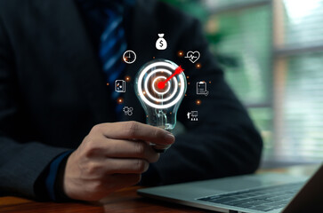 Businessman holding digital target with arrow hitting bullseye, representing business strategy, success, goal achievement, marketing focus, and precision planning in corporate management concept.