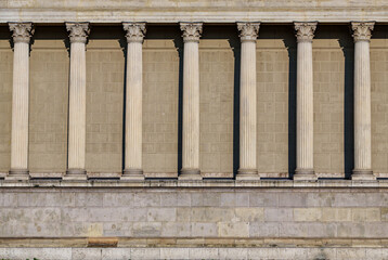 Naklejka premium Columns and wall of an old building as an abstract background, architectural details