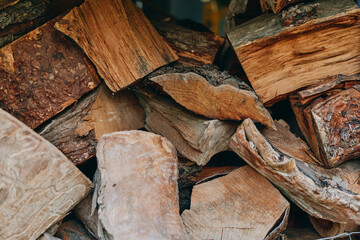 firewood, woodpile, chopped wood, logs, stacked wood, kindling, hardwood, fireplace fuel - Closeup of seasoned split logs in a rustic backyard stack, autumn atmosphere, prepared by a middle-aged man