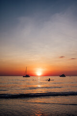 Sailboats and Swimmers at Sunset Over the Calm Sea on Koh Chang