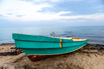 Panga style boat sit on beach ready for use