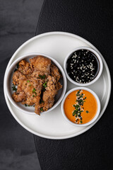 Chicken nuggets with sauces on a white plate isolated for menu