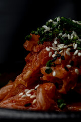 Cabbage kimchi close-up isolated on dark background