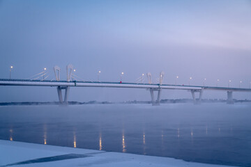 Winter view of an Illuminated bridge crossing the Zeya River in Blagoveshchensk, Russia.