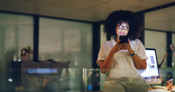 Woman, phone and night at startup, contact or glasses with deadline for social media marketing. Person, smartphone and review with app, scroll or check notification with overtime at digital agency - Powered by Adobe