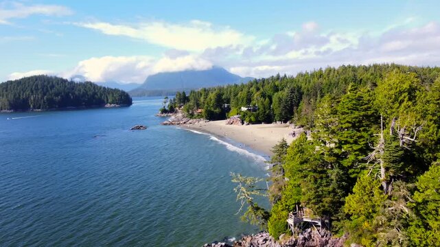 Turquoise water gently caresses the sandy shores of mackenzie beach, nestled amidst lush evergreen forests, offering a tranquil escape on vancouver island
