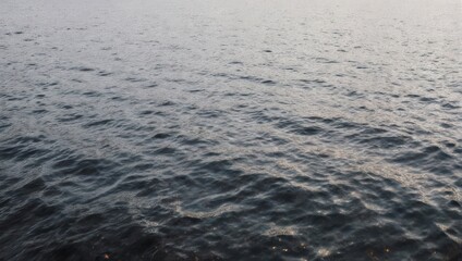 Fototapeta premium Calm Ocean Surface with Gentle Ripples and Overcast Sky.