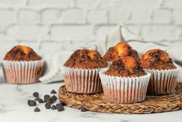 Closeup of homemade chocolate muffins and kitchen cloth