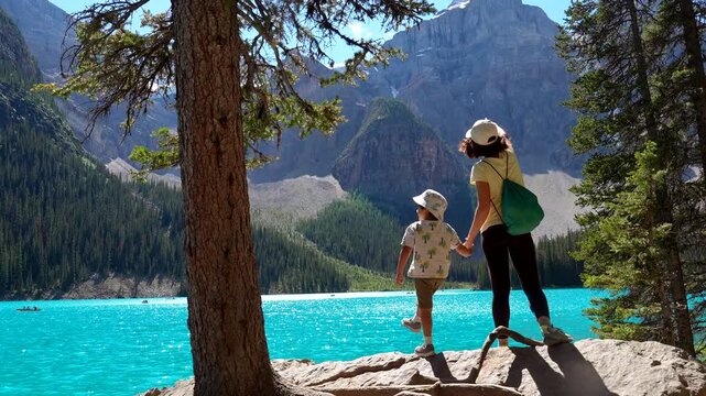 Tourists enjoying breathtaking views of turquoise waters and majestic mountains at moraine lake in banff national park, canada, creating unforgettable memories