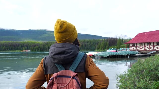 Majestic maligne lake, nestled in the heart of jasper national park, captivates a tourist with its pristine beauty and the iconic boathouse