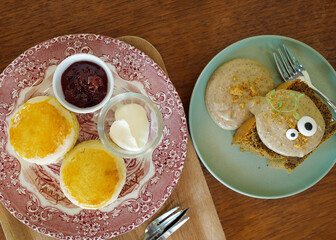 Close up Earl grey cake and butter scone served with clotted cream and strawberry jam