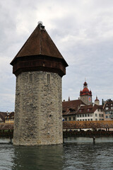 View of the water tower and the Chapel Bridge over the Reuss River in Lucerne, Switzerland