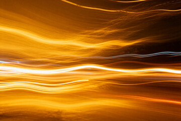Abstract Light Streaks of Golden and Orange Waves