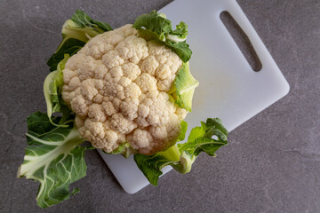 Fresh cauliflower on a chopping board