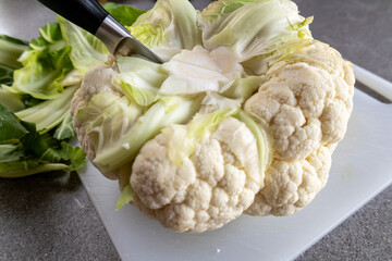 Whole cauliflower with knife, food preparation concept