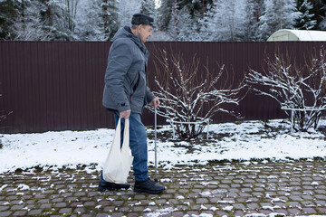 Senior person moving carefully on icy pavement, outdoor home area, cold season conditions, stability assistance visible.