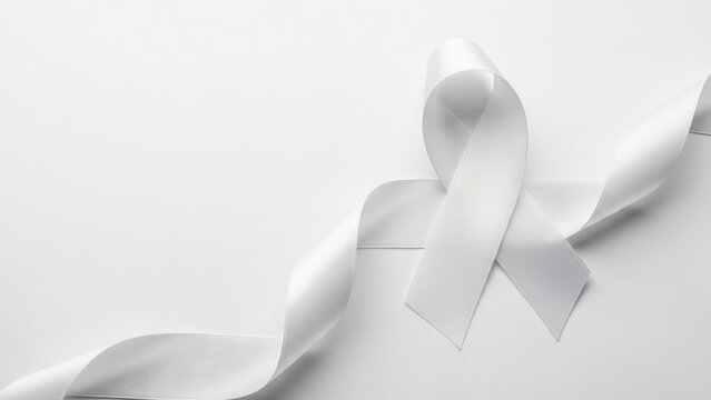 Elegant white satin ribbon gracefully dd and folded on a minimalist white background, symbolizing hope and awareness.