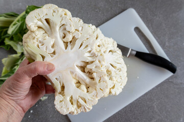 Healthy eating concept with hand holding cauliflower