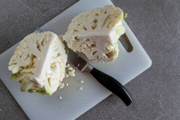 Minimal kitchen concept with cauliflower on white board