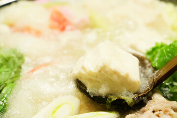 Hot pot filled with grated daikon radish, vegetables, meat, crab, and more—a winter gourmet delight