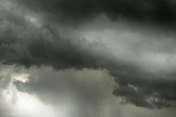 A large, dark storm cloud is approaching.