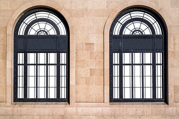 Vintage sand stone wall and black smoked steel frame windows