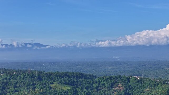 Aerial view across Southern Davao looking toward Mount Apo shrouded in clouds, the Philippines highest mountain