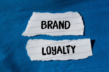 Brand loyalty message written on ripped torn paper background. Conceptual Brand loyalty symbol. Copy space.